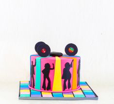 a cake decorated with the silhouettes of two people dancing on top of each other