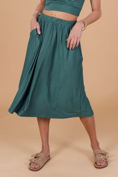 Go with the flow in this loose-fitting emerald green midi skirt. With an elastic waistband and pockets, comfort and functionality come hand in hand. Perfect for any casual occasion. Fit and features Loose fit Midi length Elastic waistband Pockets Emerald colour This Shoko product -Is designed and made with love from our Shoko team that works in a fair trade environment. -Can be customized, so you will always get the fit you desire or the design of your dreams. Just ask for it! There may be sligh Emerald Colour, Green Midi Skirt, Go With The Flow, Jumpsuit Skirt, Emerald Color, How To Make Clothes, Hand In Hand, Playsuit Jumpsuit, Fair Trade