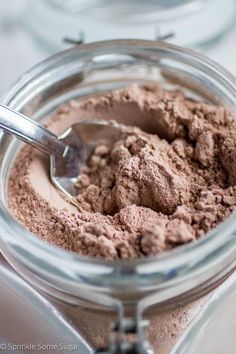 a jar filled with dirt and a spoon