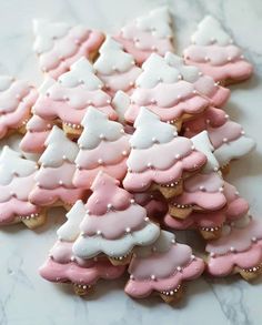 some pink and white decorated cookies on a table