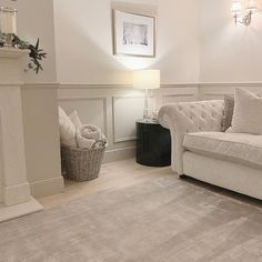 a living room filled with furniture and a fire place next to a white fireplace mantel