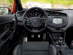 the interior of a car with black leather and red stitching