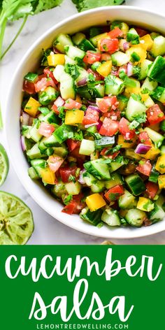 cucumber salsa in a white bowl surrounded by limes and cilantro