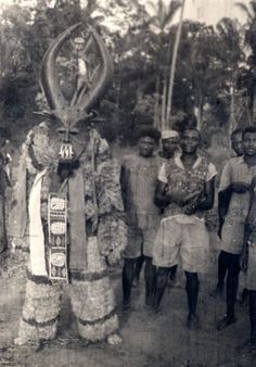 an old black and white photo of people dressed up in animal costumes, standing next to each other