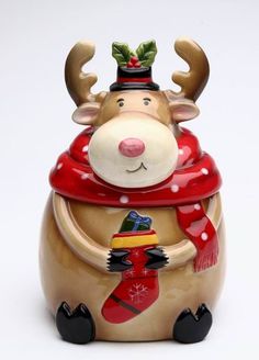 a ceramic figurine wearing a red scarf and hat with antlers on it