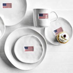 two cupcakes and one plate with an american flag sticker sitting on it