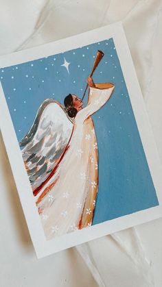 an angel holding a baseball bat on top of a white sheet with stars in the sky