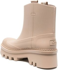 Step out in style, rain or shine, with these chic and practical ankle-length rain boots. The blush beige color and contrasting toecap add a fun and fashionable touch, while the pull-on style makes them easy to slip on and off. With a sturdy rubber sole and mid block heel, these rain boots are as comfortable as they are stylish. Blush beige color Pull-on style Contrasting toecap Ankle-length Segmented rubber sole Mid block heel | Chloé Women's Raina Rubber Rain Boots in Beige | Size IT 36 | CHC23 Rain Or Shine, Prada Designer, Designer Sunglasses, Beige Color, Watch Design, Bottega Veneta, Ankle Length, Rubber Rain Boots, Rain Boots