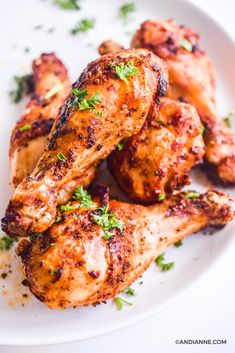 grilled chicken wings with parsley on a white plate