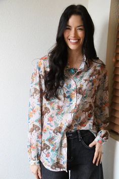 Introducing the Hawaiian Paniolo Cowboy Blouse - a unique blend of Hawaiian flair and classic Cowboy style. This button-down blouse is a fun way to embrace both trends and make a statement. Perfect for anyone looking to stand out with a touch of playful sophistication. Hawaiian Paniolo Cowboy Blouse Polyester Color - Cream Background Multicolor Button-up Top With Button Cuffs, Multicolor Tops With Button Cuffs For Fall, Multicolor Long Sleeve Tops With Button Cuffs, Fall Multicolor Tops With Button Cuffs, Classic Cowboy, Buckle Bags, Satin Long Sleeve, Wild Rag, Denim Outerwear