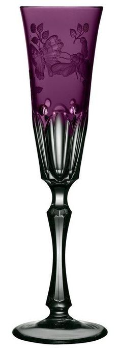 a purple glass vase sitting on top of a table