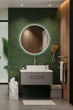 a bathroom with green walls and a round mirror on the wall above the sink, along with a white rug