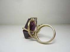 "This completely unique and one of a kind ring was purchased from the estate of a jewelry designer who made many custom and unique pieces in our local area around Cleveland, Ohio in the 70's and 80's. The 14k gold setting features a split ring shank and gold leaves that circle around and beneath the gigantic gemstone. The gemstone is a violet-blue to purple color-change sapphire in a free form cut. Gemstone Dimensions - 27mm x 18mm x 9.5mm Ring Size 5.5. (Can easily be resized to most sizes) Mar 14k Gold Jewelry With Unique Design For Formal Occasions, Formal 14k Gold Jewelry With Unique Design, Modern 14k Gold Collectible Jewelry, Unique 14k Gold Rings With Polished Finish, Modern Yellow Gold Collectible Rings, Collectible Modern 14k Gold Jewelry, Formal Fine Jewelry With Unique Design, 14k Gold Ring With Unique Design, Modernist Hallmarked 14k Gold Jewelry