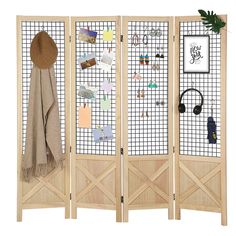 the room divider is made out of wood and has earring hooks on it