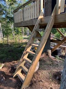 a tree house with stairs leading up to it