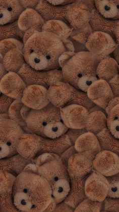 a large group of brown teddy bears sitting together