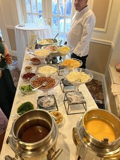 a man standing in front of a buffet table filled with food