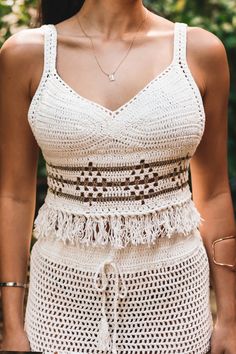 Obsessing over the Izzy crochet top! We're planning our next vacation just to wear this outfit! Mix & Match with your favorite bottoms for summer jeans or shorts! Color: Natural with gold detail Crochet Small V neck cami scalloped trim hem Lined in all the right areas Can be worn without a bra(closed stitch) Not sheer in the front Tassel trim detail Back button closure Runs small, model is wearing M Model is wearing a size Medium. She is 5'5". 124 lbs. Bust: 32C Waist 26" Hips 36 1/2 Crochet Lace V-neck Crop Top For Summer, Chic Summer Crochet Top With Crochet Trim, Cotton Crochet Top With Crochet Trim For Beach Season, Cotton Crochet Top With Trim For Beach Season, Chic Crochet Lace Crop Top For Vacation, Fitted Summer Crochet Top For Vacation, Chic Cotton Crochet Top For Vacation, Chic Crop Top With Crochet Trim For Beach, Beachy Crochet Top For Summer Day Out