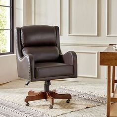 a brown leather office chair sitting on top of a rug