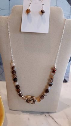 This Jasper Necklace is beaded with round beads and the stunning rectangular bead accents the middle of this 22" necklace. Rectangular Gemstone Beaded Necklaces For Gifts, Rectangular Gemstone Beaded Necklace For Gift, Elegant Rectangular Beaded Necklaces As Gifts, Elegant Rectangular Beaded Necklaces For Gifts, Elegant Rectangular Beaded Necklace For Gift, Elegant Rectangular Beaded Necklace Gift, Brown Necklace With Silver Beads For Gift, Elegant Rectangular Polished Beads Jewelry, Handmade Jasper Round Necklaces