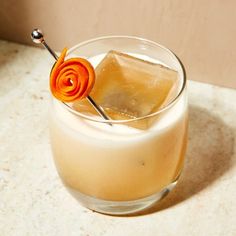 a drink with an orange flower on the top