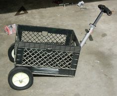 a black shopping cart sitting on top of a cement floor