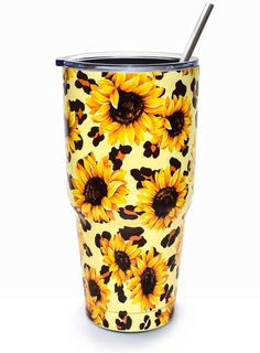 a yellow and black sunflower pattern tumbler with a straw in the cup, on a white background