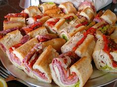 a platter full of sandwiches on a table