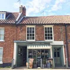 an old brick building with a store front