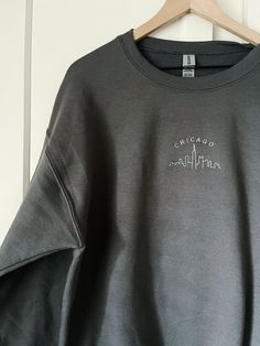 This is a made to order item. Please allow up to 2 weeks before item is shipped.  Embroidered crewneck sweatshirt. 50% preshrunk cotton, 50 % polyester. Unisex fit. Design size is approximately 4 inches wide.  Color: charcoal gray. Cotton Crew Sweatshirt, Cotton Crew Neck Sweater, Crew Neck Sweatshirt With Embroidered Logo, Crew Neck Cotton Sweater With Embroidered Graphics, Cotton Crew Sweater With Embroidered Graphics, Embroidered Relaxed Fit Crew Sweatshirt, Oversized Crew Neck Sweatshirt With Embroidered Logo, Gray Sweater With Embroidered Logo For Streetwear, Relaxed Fit Embroidered Crew Sweatshirt