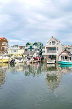 several boats are docked in the water next to houses