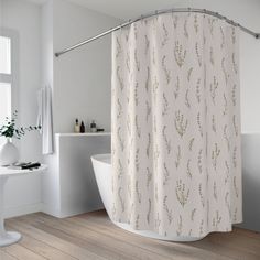 a white bath tub sitting next to a shower curtain