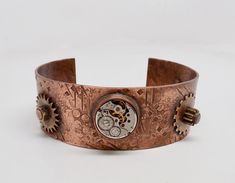 Awesome mixed metal steampunk cuff bracelet made of 16 gage solid copper, watch movement and gears. . All the gear parts are riveted to the cuff . I patina the cuff to give it a vintage look and then I sealed it to prevent tarnishing. The cuff is 1 "wide by 6 1/2 " around. More steampunk bracelets in my shop www.etsy.com/shop/slotzkin Steampunk Bracelet, Watch Movement, Arm Band, Bracelet Making, Vintage Look, Vintage Looks, Cuff Bracelet, Cuff Bracelets, Rum