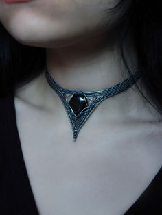 This one of a kind choker features a glittering silver sheen obsidian in sterling silver wire, finished with your choice length of sterling silver chain for ease of adjustment. design © Dream Residue Jewelry Each order arrives packaged with a list of healing properties and jewelry care info. I always update my instagram first, follow me to shop my story sales for exclusive items: @DreamResidueJewery If you have any questions at all, or would like more photos or a video- please message me before purchasing. Custom orders are available! Choose your crystal or send me your own special crystal/item, discuss design, pick your wire, and choose your budget. Message me for more info or to start yours. Necklace With Outfit, Choker Necklace Styling, Cloth Choker, All Silver Jewelry, Frame Necklace, Choker Necklace Aesthetic, Cloth Choker Necklace, Jeweled Choker, Simple Jewelry Design