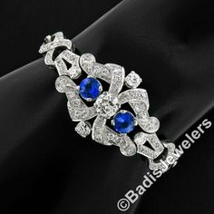 "Here we have an absolutely stunning art deco period bracelet, which was crafted from solid .900 platinum, featuring a GIA certified old European cut diamond at its center flanked by a pair of natural royal blue sapphires. The center diamond weighs exactly 1.14 carats and is certified to be K in color and an eye-clean SI1 clarity. The sapphires are a gorgeous well-matched royal blue color and are exceptionally brilliant. The open work is immaculate and the entire piece is framed with very fine m Art Deco Hallmarked Bracelet For Anniversary, Art Deco Brilliant Cut Bracelets For Anniversary, Art Deco Brilliant Cut Bracelet For Anniversary, Art Deco White Gold Diamond Bracelet, Art Deco Anniversary Bracelet With Brilliant Cut, Art Deco Diamond Bracelet For Anniversary, Art Deco Diamond Bracelet As Gift, Art Deco Anniversary Bracelet, Art Deco White Gold Diamond Bracelet Gift