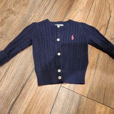 Nwot! Features A Navy Cable Knit Button Up Sweater With Pink Ralph Lauren Logo On It. Size: 6 Months Cute Cotton Sweater With Buttons, Cute Cotton Buttoned Sweater, Blue Cotton Ralph Lauren Sweater, Ralph Lauren Blue Cotton Sweater, Blue Long Sleeve Ralph Lauren Sweater, Blue Cotton Sweater With Button Closure, Ralph Lauren Long Sleeve Cotton Cardigan, Cute Ralph Lauren Long Sleeve Top, Casual Cotton Ralph Lauren Cardigan