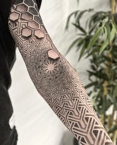 a man's arm with an intricate tattoo design on the left side of his arm