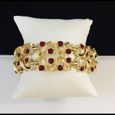 Vintage Signed Coro Red Crystal Bracelet Elegant Textured Goldtone Raised Open Work Design Mid Century Circa 1950’s Dimensions: 7 1/4” L X 1” W Elegant Red Bracelets For Party, Vintage Red Bracelets For Party, Elegant Red Bangle Bracelets, Elegant Red Bangle Bracelet, Red Vintage Party Bracelets, Red Jubilee Bracelets For Parties, Red Jubilee Bracelet For Party, Vintage Red Bracelets For Wedding, Vintage Red Bracelet For Wedding