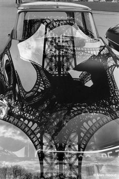 a car is shown with the eiffel tower reflected in it's rear window