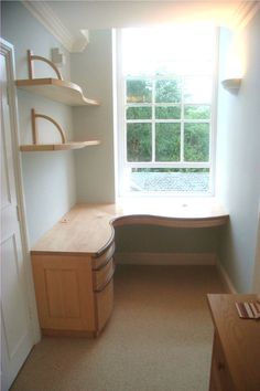 a room with a window, shelves and a bench in the corner next to it