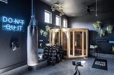 a gym with an indoor sauna and punching bag