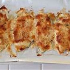 some food is laying out on a white tray and ready to be cooked in the oven