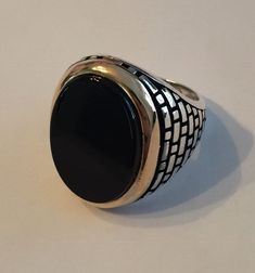 "Gorgeous mens 925 silver black onyx ring. Nice large oval stone 20x23mm (Almost 1\") Solid 925 sterling silver...blackened (oxidized) ridges for a vintage look Bezel of stone is made from solid 10k gold Natural black onyx...semi precious stone! No two ring are alike...gorgeous handmade item! Weighs roughly 13-15 grams depending on ring size Can be worn as a signet ring or as a pinky ring. Even as a ring on your middle or index finger :) We have in sizes 7-13 Ships within 1-2 business days" Black Sterling Silver Signet Ring With Polished Finish, Classic Black Oval Cabochon Ring, Black Oval Signet Ring For Formal Occasion, Formal Black Oval Cabochon Signet Ring, Formal Black Oval Signet Ring, Formal Black Oval Ring, Formal Black Oval Rings, Black Sterling Silver Signet Ring For Anniversary, Black Oval Cabochon Jewelry For Anniversary