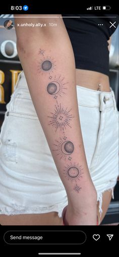 a woman's arm with the sun and planets on it