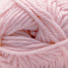 a ball of pink yarn is shown in close up