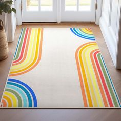 a colorful rug on the floor in front of a door