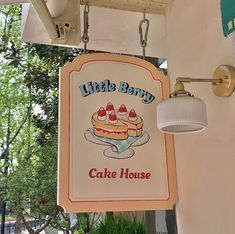 a sign hanging from the side of a building that says little barry's cake house