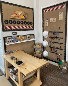 a wooden table sitting in front of a bulletin board