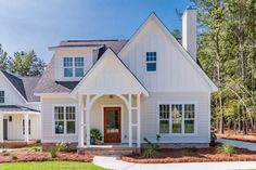 a white house with lots of windows in the front yard