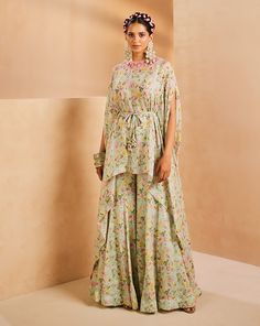 Featuring a fun floral foliage printed kaftan top and sharara set. The neckline is fully hand embroidered with colorful sequences and bugle beads. The front tie-up is accentuated with mirror and cowry shell detailing.From Aneesh Agarwaal's Seher collection.DELIVERY TIMEPlease allow 8-12 weeks for your outfit to arrive.FABRIC DETAILSChinonProfessional cleaning only. Top And Sharara Set, Printed Sharara, Blue Kaftan, Prints Colorful, Printed Kaftan, Floral Foliage, Kaftan Top, Kaftan Designs, Cowry Shell